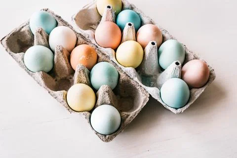 Easter Getting ready concept. Colored Easter eggs in two cartons. Stock Photos