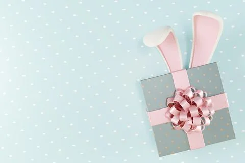Easter gift box with bunny ears and a decorative bow Stock Photos