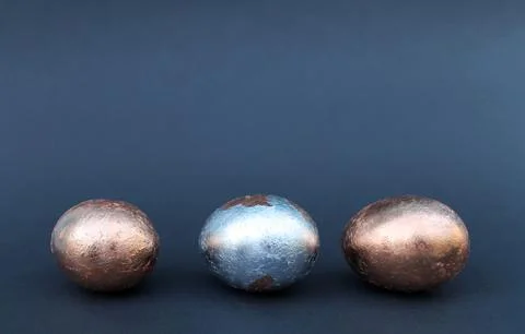 Easter Gold and silver egg on black background Stock Photos
