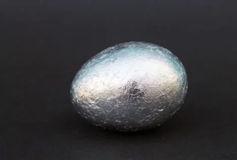 Easter Gold and silver egg on black background Stock Photos