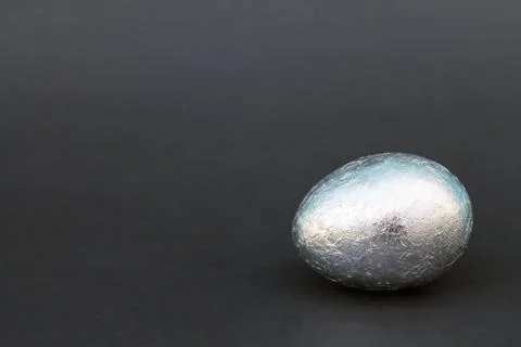 Easter Gold and silver egg on black background Stock Photos