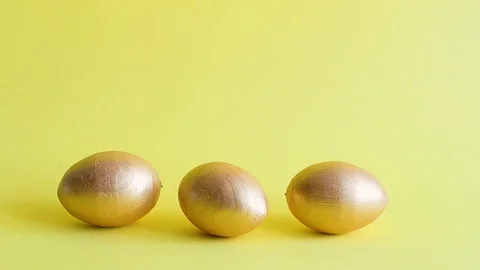 Easter gold decorative eggs on yellow background Stock Footage 128106968