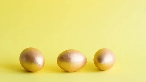 Easter gold decorative eggs on yellow background Stock Footage 128107065