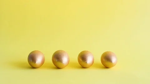 Easter gold decorative eggs on yellow background Stock Footage 128107544