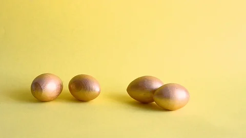 Easter gold decorative eggs on yellow background Stock Footage 128109181