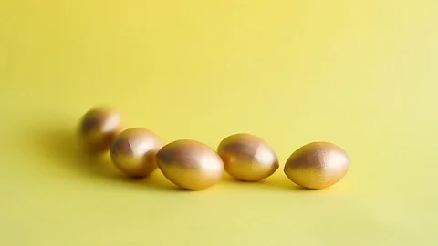 Easter gold decorative eggs on yellow background Stock Footage 128109440