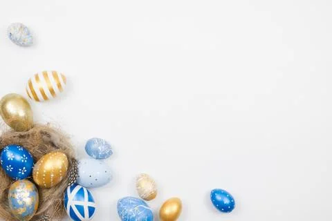 Easter golden decorated eggs in nest isolated on white background. Minimal 스톡 사진