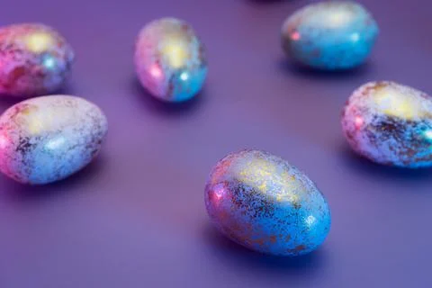 Easter golden eggs with different patterns in neon colors light. Purple very Stock Photos