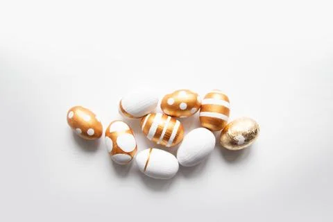 Easter golden eggs pattern on a white background with place for text. 스톡 사진