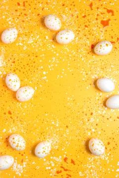 Easter greeting background with eggs paint splashes Stock Photos