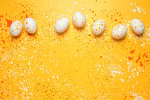 Easter greeting background with eggs paint splashes Stock Photos