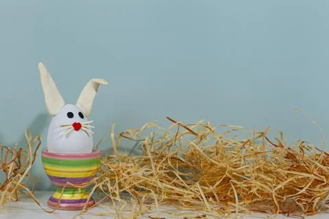 Easter greeting card. Easter egg with bunny ears on a stand. Stock Photos