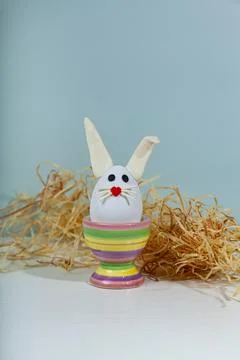 Easter greeting card. Easter egg with bunny ears on a stand. Stock Photos