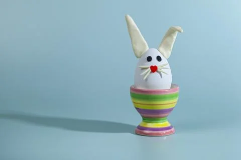 Easter greeting card. Easter egg with bunny ears on a stand. Stock Photos