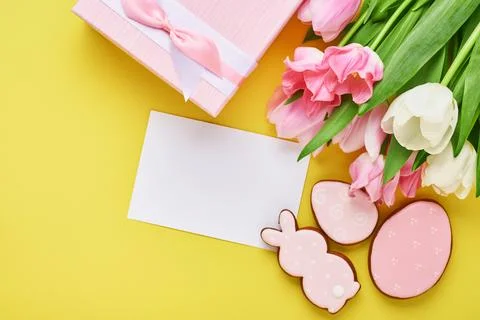 Easter greeting card with easter gingerbread eggs gift box and tulip flowers  Stock Photos