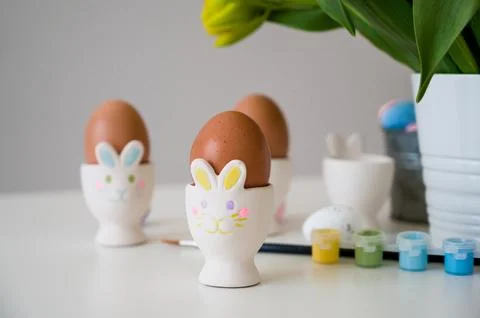 Easter greeting card eith pastel paint,eggs in bunny holders etc Stock Photos