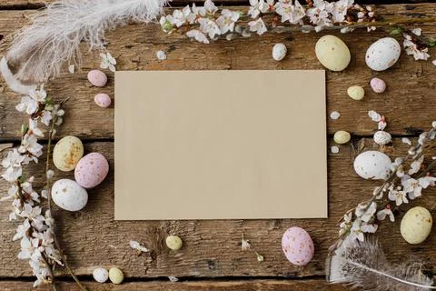 Easter greeting card mockup, rustic flat lay. Empty card, easter candy eggs.. Stock Photos