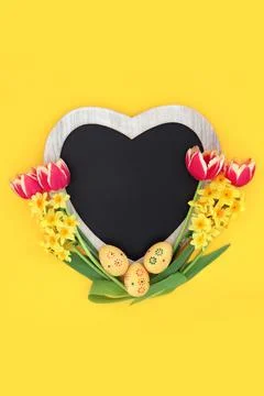 Easter Heart Shaped Frame with Eggs and Spring Flowers Stock Photos