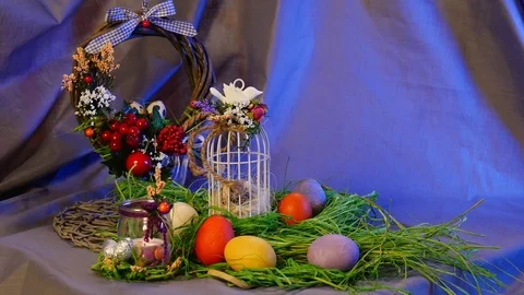 Easter Hen and Quail Eggs, a Bottle With a Lit Candle, a Brown Ring, and a Top Stock Footage 72881994