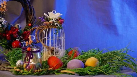 Easter Hen and Quail Eggs, a Bottle With a Lit Candle, a Brown Ring, and a Top Stock Footage 72882335