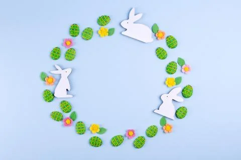 Easter holiday background. Top view of green sugar candy eggs, wooden bunny Stock Photos