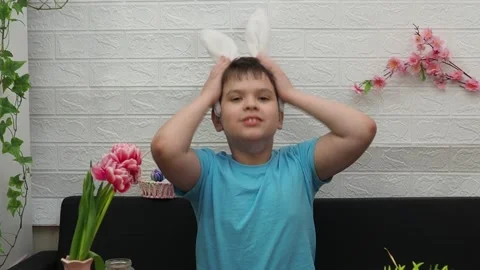 Easter holiday.  bunny ears. A boy  paints an Easter egg. Preparing for Easter 스톡 동영상 173751005