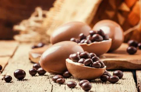 Easter holiday composition with chocolate eggs and sweets, rustic style, vint Stock Photos