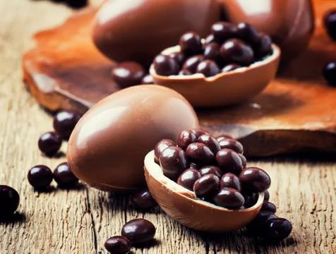Easter holiday composition with chocolate eggs and sweets, rustic style, vint Stock Photos