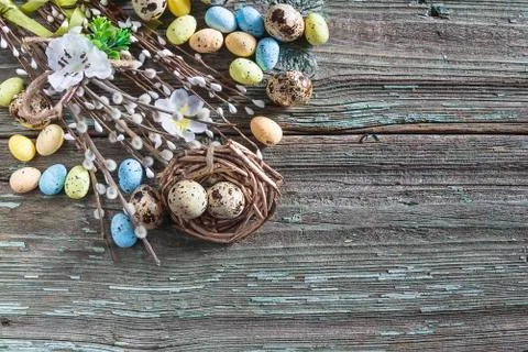 Easter holiday composition on old paint wooden background. Quail eggs, nest a Stock Photos