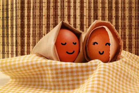 Easter Holiday Concept Two Egg Hooded Smile on a Yellow Napkin with Dark Brow Stock Photos