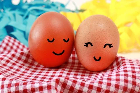 Easter Holiday Concept Two Eggs Smile Happiness on a Red Napkin with Blue Yel Stock Photos