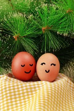 Easter Holiday Concept Two Eggs Smile Happiness on a Yellow Napkin with Green Stock Photos