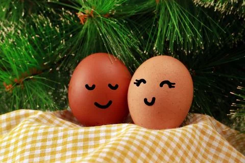 Easter Holiday Concept Two Eggs Smile Happiness on a Yellow Napkin with Green Stock Photos