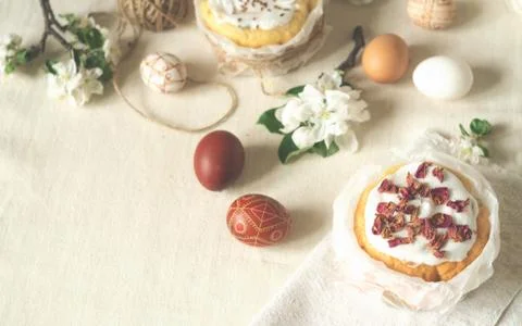 Easter holiday. Easter cakes, easter eggs and flowering apple tree branches Stock Photos