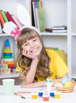 Easter holiday - kid coloring eggs Stock Photos