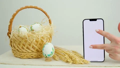 Easter holiday phone with white background basket eggs with embroidered pattern Stock Footage 233071187