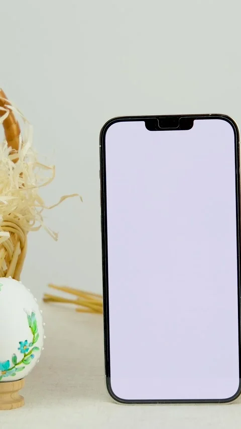 Easter holiday phone with white background basket eggs with embroidered pattern Stock Footage 247365321
