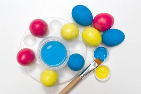Easter holiday. The process of painting an egg on a white background. Paint,  Stock Photos