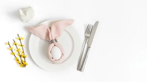 Easter holiday table setting with egg in pink napkin Easter Bunny  Stock Photos