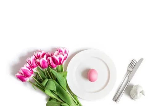 Easter holiday table setting with pink chicken egg, rabbit and tulip flowers  Stock Photos