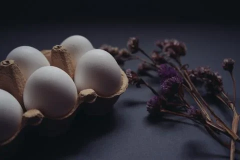 Easter holidays concept. Close up composition of white easter eggs in carton box Stock Photos