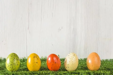 Easter holidays greeting card template; Easter eggs on a grass against whit.. Stock Photos