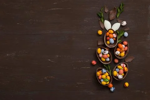Easter hunt concept background with chocolate Easter eggs on wooden table c.. Stock Photos