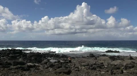 Easter Island waves break left and right of tourist 1a Stock Footage