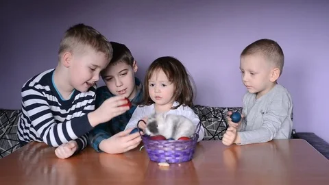 Easter, kids are playing with Easter bunny and eggs Stock-Footage 78991929