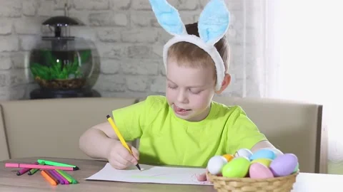 Easter kids. A happy boy with rabbit ears on his head smiles, plays at home Stock Footage 176283407