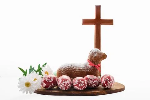 Easter lamb cake with decorated eggs and wooden cross Stock Photos