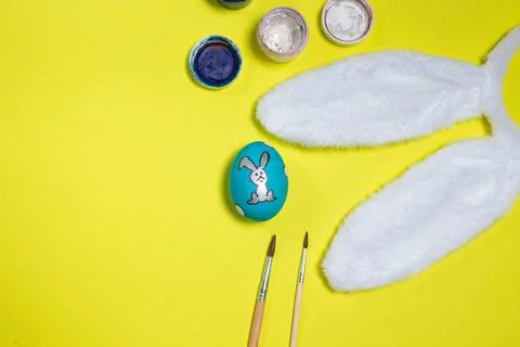Easter layout: egg, paint, tasses and rabbit ears. Stock Photos