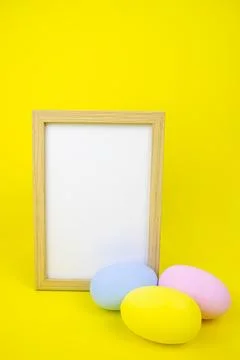 Easter layout. Frame for copy space isolate, on a yellow background and eggs. Stock Photos