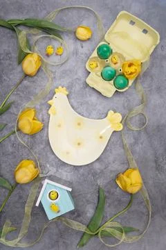Easter layout, a plate of chicken and yellow chicks, by green eggs ,tulips Stock Photos